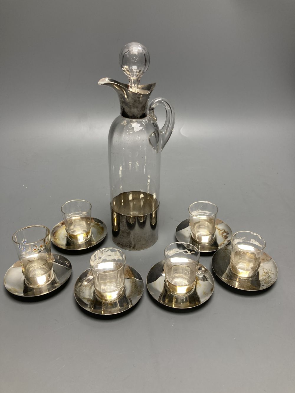 An Edwardian silver mounted glass seven piece liqueur set, by Hukin & Heath, Birmingham, 1906,